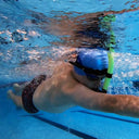 Person swimming underwater in a pool with goggles and snorkel