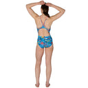 Woman wearing a colorful swimsuit with a white background