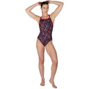 Woman wearing a patterned swimsuit on a white background