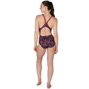 Woman wearing a patterned swimsuit on a white background