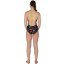 Woman wearing a colorful swimsuit with a geometric pattern on a white background