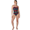 Woman wearing a colorful zebra-patterned swimsuit on a white background