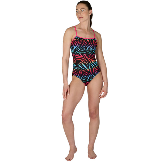 Woman wearing a colorful zebra-patterned swimsuit on a white background