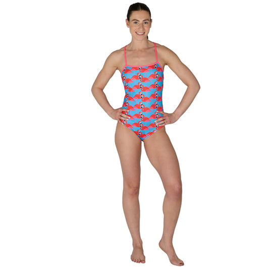 Woman wearing a colorful swimsuit with a pattern on a white background