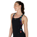 Woman wearing a black swimsuit with colorful patterns on a white background