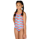 Young girl wearing a Maru flamingo-patterned swimsuit on a white background